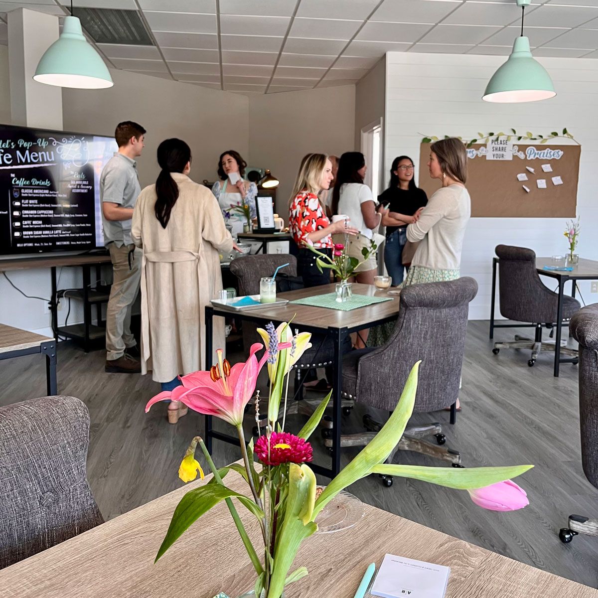 Studio office space with flower arrangement and group gathering