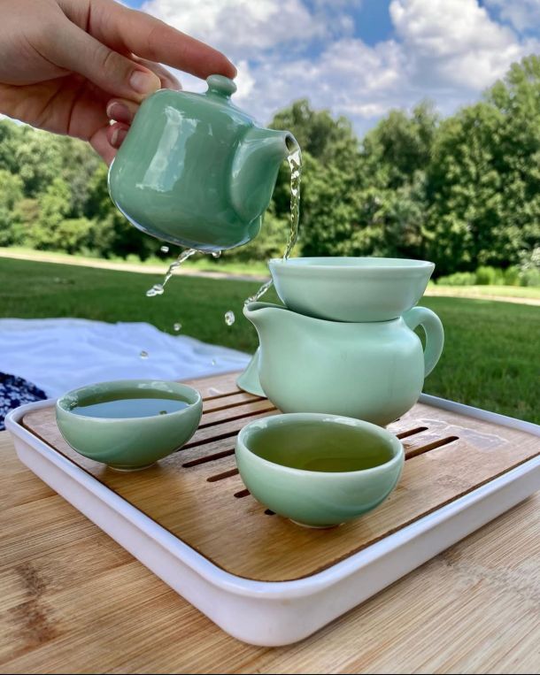 pouring tea with a celadon gong fu tea set outside on a picnic